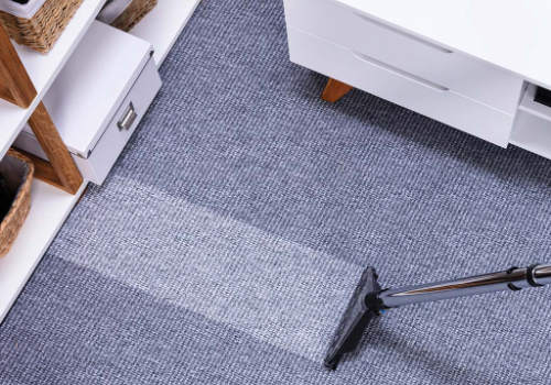 A carpet cleaning machine is being used to clean the floor.